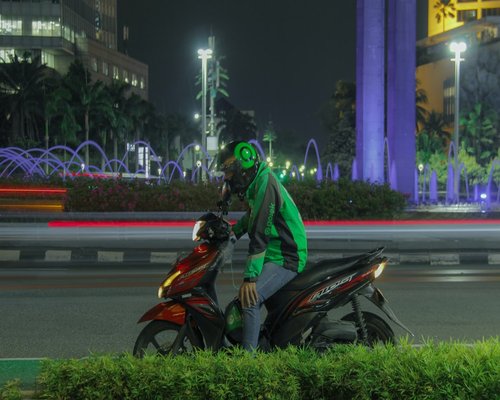 Jakarta commuter resting during an evening trip