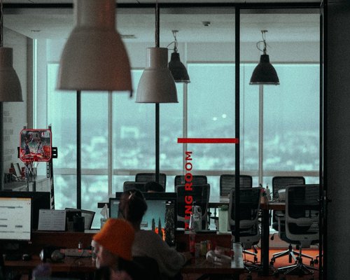 People collaborating around laptops in an Indonesian office
